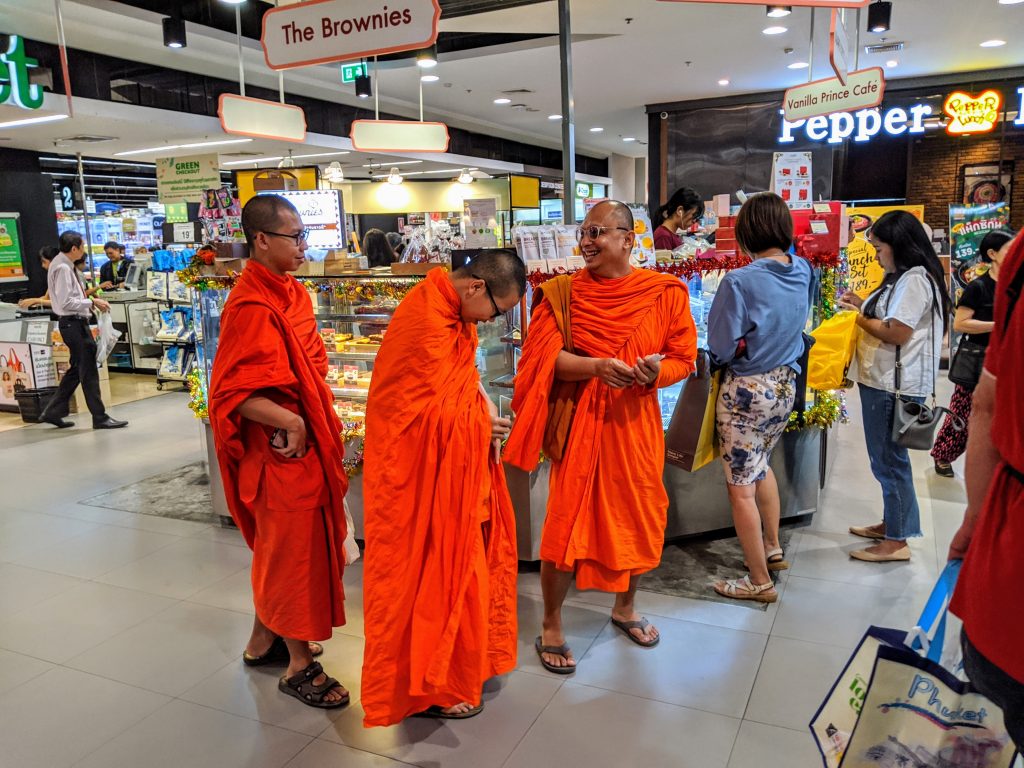 Buddhist monks shopping in modern mall in Bangkok